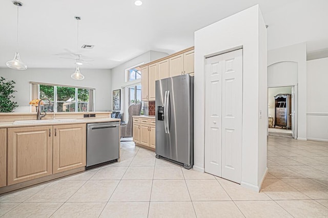 kitchen featuring light brown cabinets, hanging light fixtures, sink, ceiling fan, and appliances with stainless steel finishes