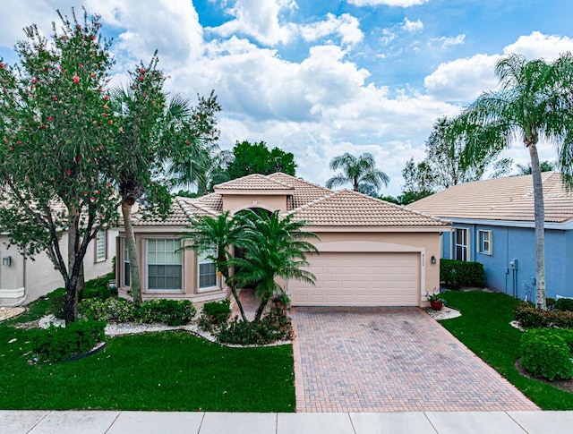 view of front of house featuring a front yard and a garage