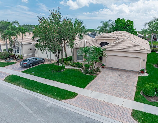 view of front facade with a front yard and a garage