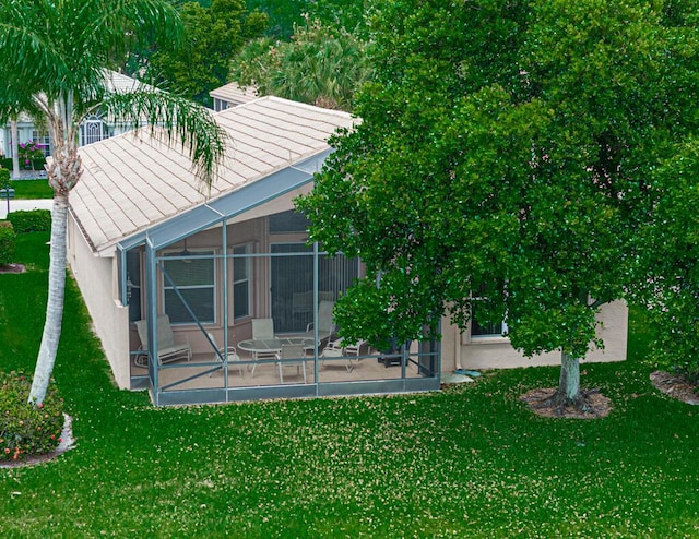 back of house featuring a sunroom and a yard