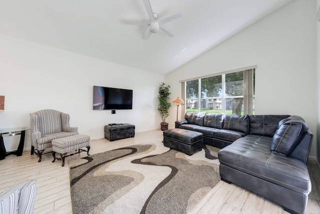 living room with hardwood / wood-style flooring, ceiling fan, and high vaulted ceiling