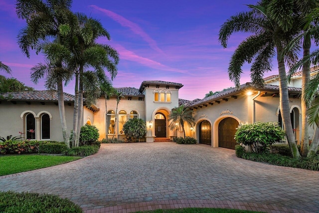 mediterranean / spanish-style house with a garage