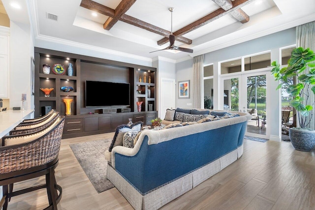 living room with coffered ceiling, beam ceiling, ceiling fan, french doors, and light wood-type flooring