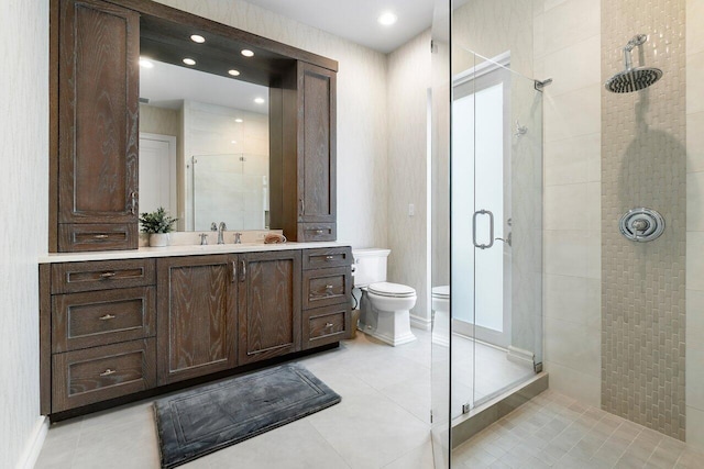 bathroom with vanity, a shower with door, tile floors, and toilet