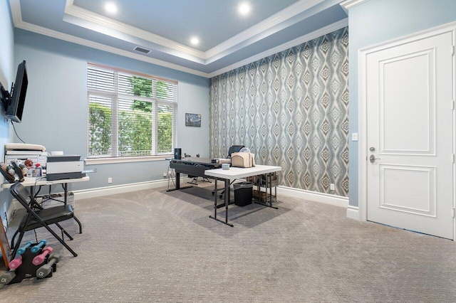 carpeted home office featuring a tray ceiling and ornamental molding