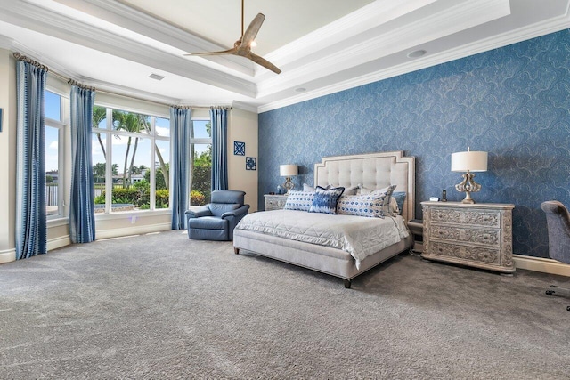 bedroom with a tray ceiling, ceiling fan, and ornamental molding