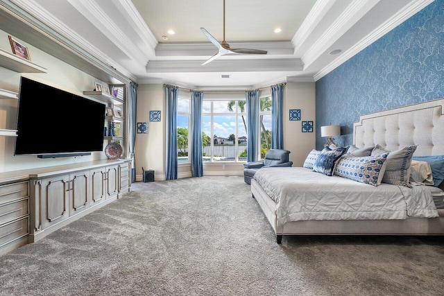 bedroom featuring ceiling fan, crown molding, dark carpet, and a raised ceiling