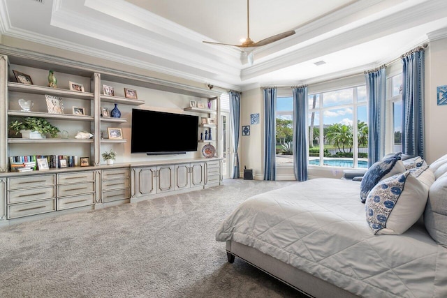 bedroom with dark carpet, ornamental molding, ceiling fan, and a tray ceiling