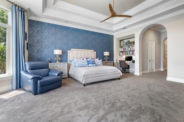 bedroom with a raised ceiling, crown molding, ceiling fan, and carpet