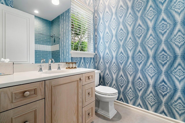 bathroom featuring tile floors, toilet, and vanity