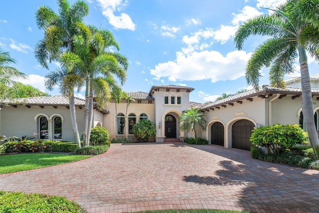 mediterranean / spanish-style home with a garage