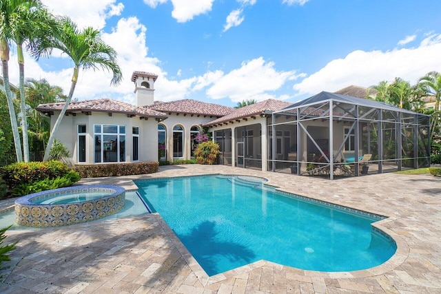 view of pool with a patio, an in ground hot tub, and a lanai