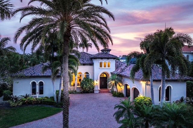 mediterranean / spanish-style home featuring french doors and a yard