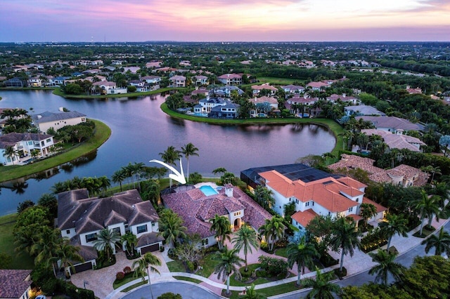 aerial view at dusk with a water view