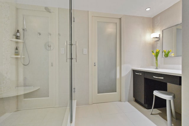 bathroom featuring vanity, tile flooring, and a shower