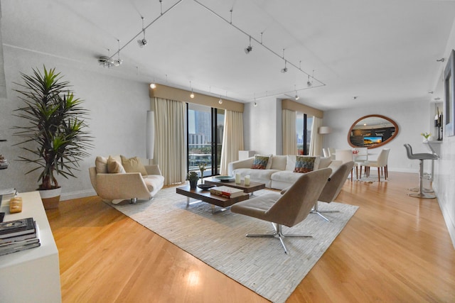 living room featuring track lighting and light hardwood / wood-style floors