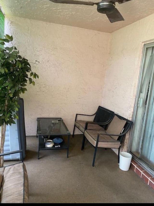 interior space with carpet floors and ceiling fan