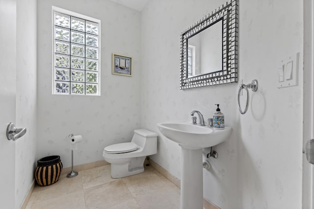 bathroom featuring sink, tile floors, and toilet