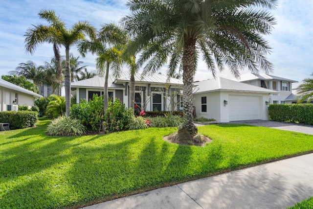 view of front of house featuring a garage and a front lawn