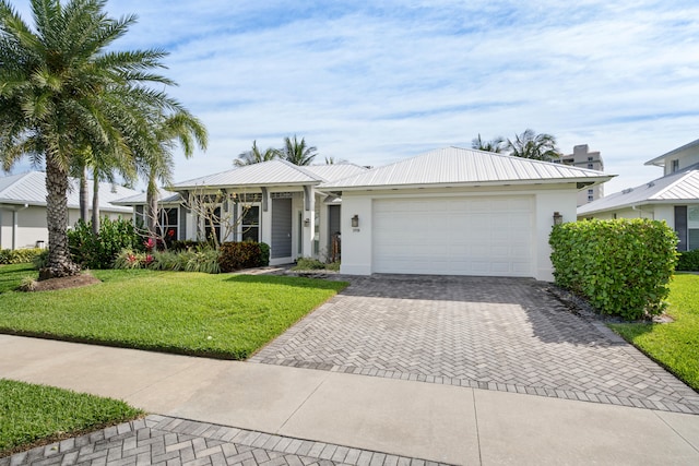 ranch-style home featuring a front lawn and a garage