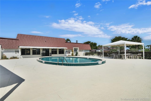 view of swimming pool featuring a gazebo and a patio