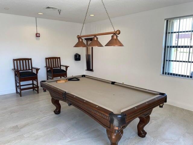 living area with ceiling fan and a textured ceiling