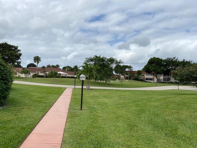 view of property's community featuring a yard