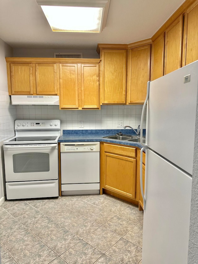 kitchen featuring backsplash, light tile floors, white appliances, and sink