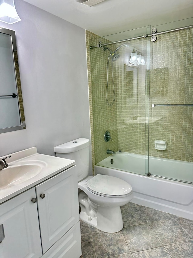 full bathroom with tile floors, toilet, shower / bath combination with glass door, and vanity