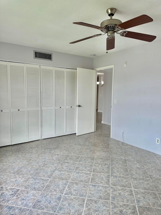 unfurnished bedroom with a closet, ceiling fan, and light tile flooring