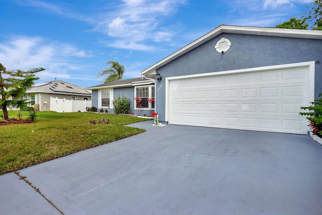 ranch-style house with a garage and a front yard