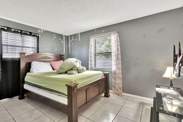 tiled bedroom featuring a textured ceiling