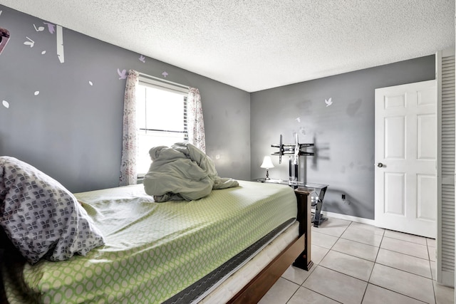 bedroom with light tile floors and a textured ceiling