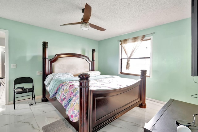 tiled bedroom featuring ceiling fan and a textured ceiling