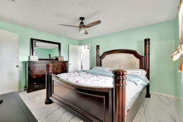 bedroom with a textured ceiling, ceiling fan, and light tile flooring