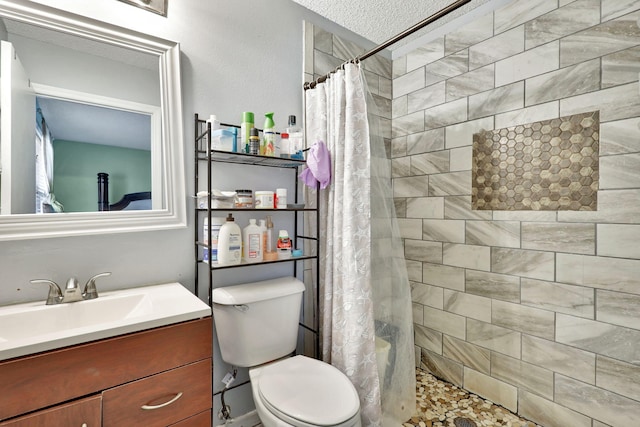 bathroom featuring walk in shower, vanity, and toilet