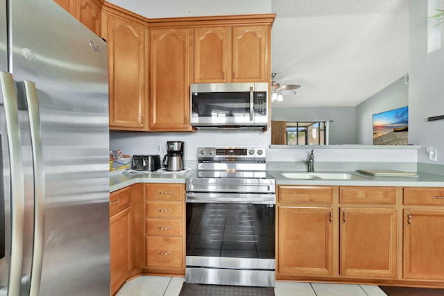 kitchen with sink, ceiling fan, light tile floors, and stainless steel appliances