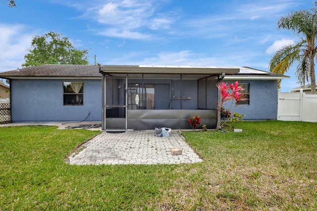 back of house with a patio area and a yard