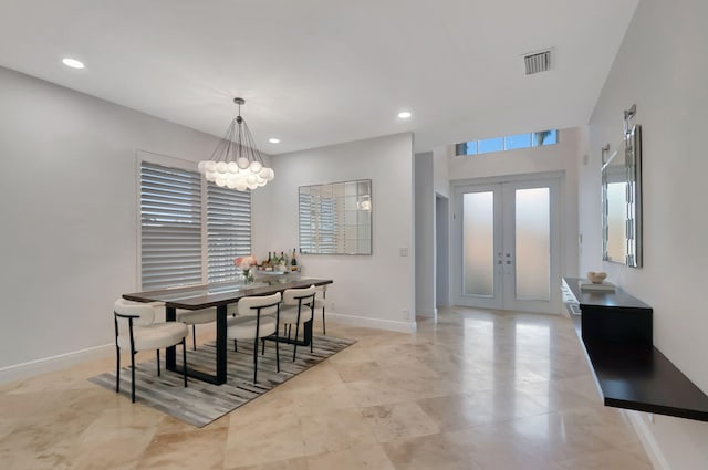 dining area featuring french doors and a notable chandelier