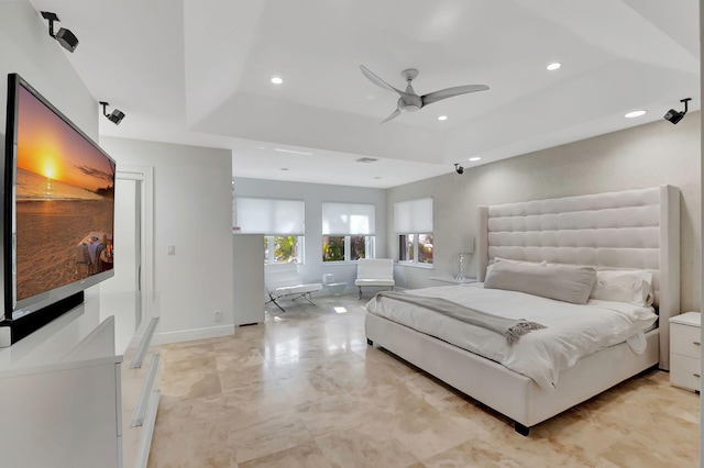 bedroom featuring a tray ceiling and ceiling fan