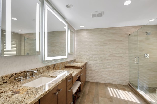 bathroom with vanity and an enclosed shower