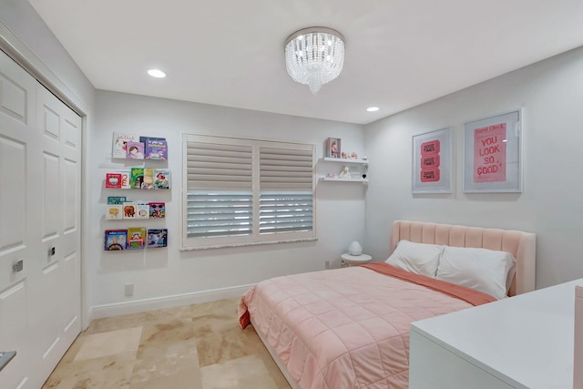 bedroom featuring a chandelier and a closet