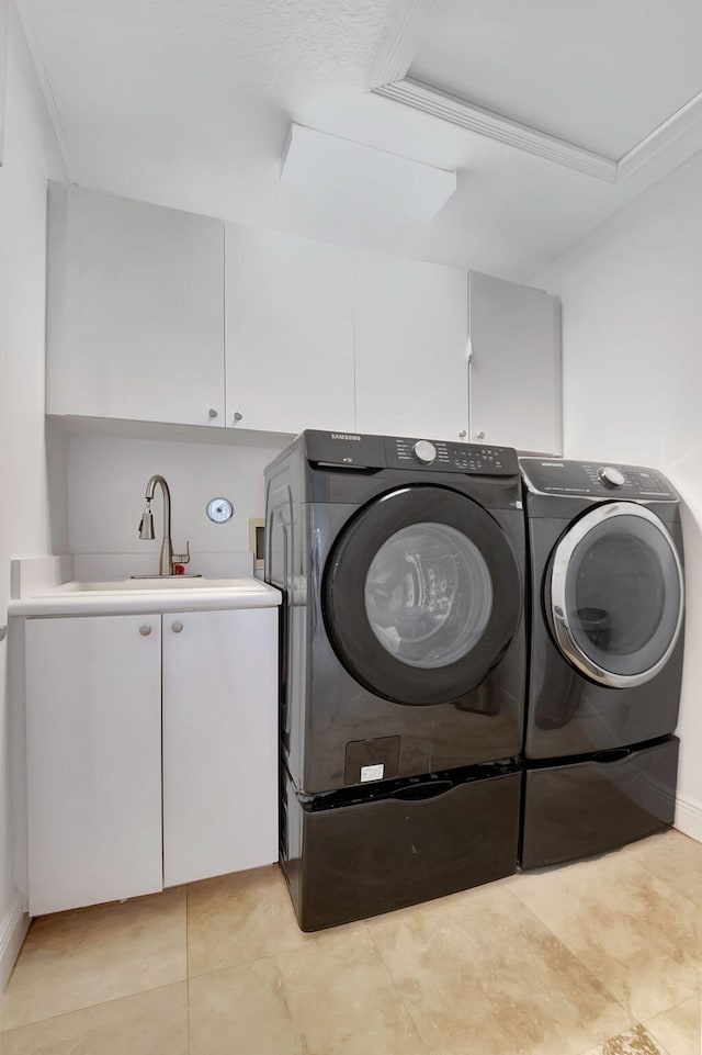 laundry room with cabinets, crown molding, sink, separate washer and dryer, and light tile patterned floors