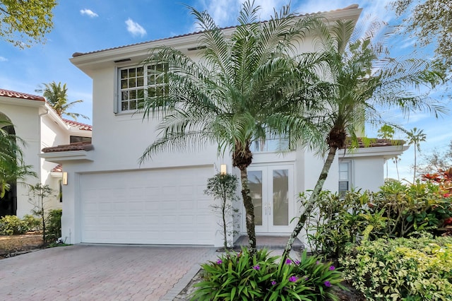 mediterranean / spanish-style home featuring french doors and a garage