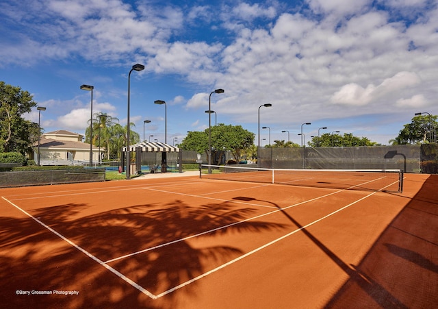 view of tennis court with basketball hoop