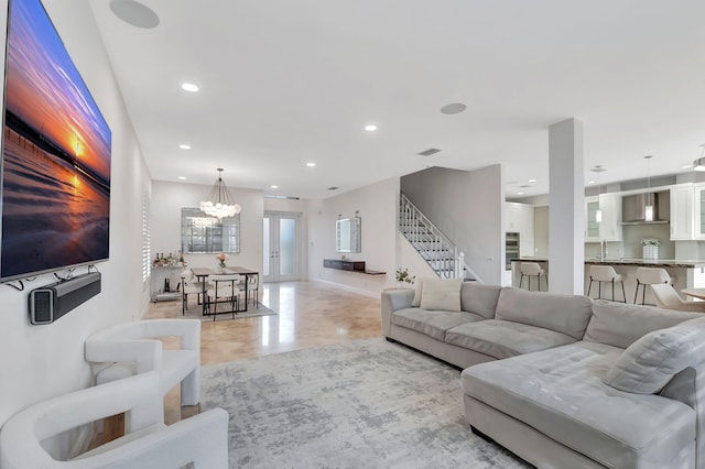 living room featuring a notable chandelier and sink