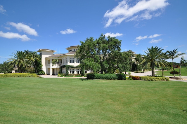 exterior space featuring a balcony and a front lawn