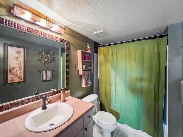 bathroom featuring tile floors, toilet, a textured ceiling, and vanity