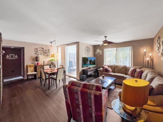 living room featuring ceiling fan and dark hardwood / wood-style flooring