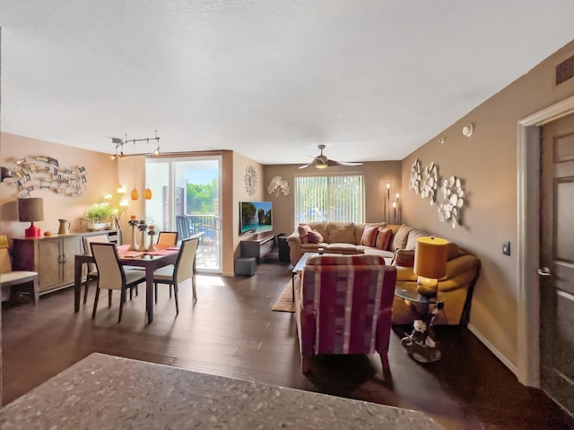 living room with rail lighting, dark hardwood / wood-style flooring, and ceiling fan